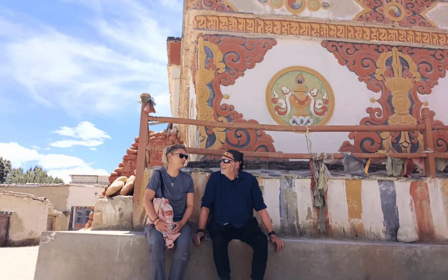 Travellers before a large painted mural inside an Upper Mustang monastery