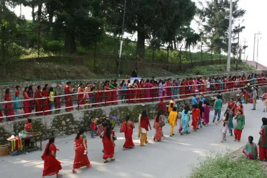 Women dancing in red at Teej festival