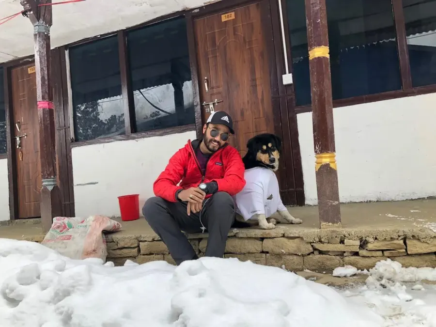 Trekker with a local stray dog at Mardi Himal Trek